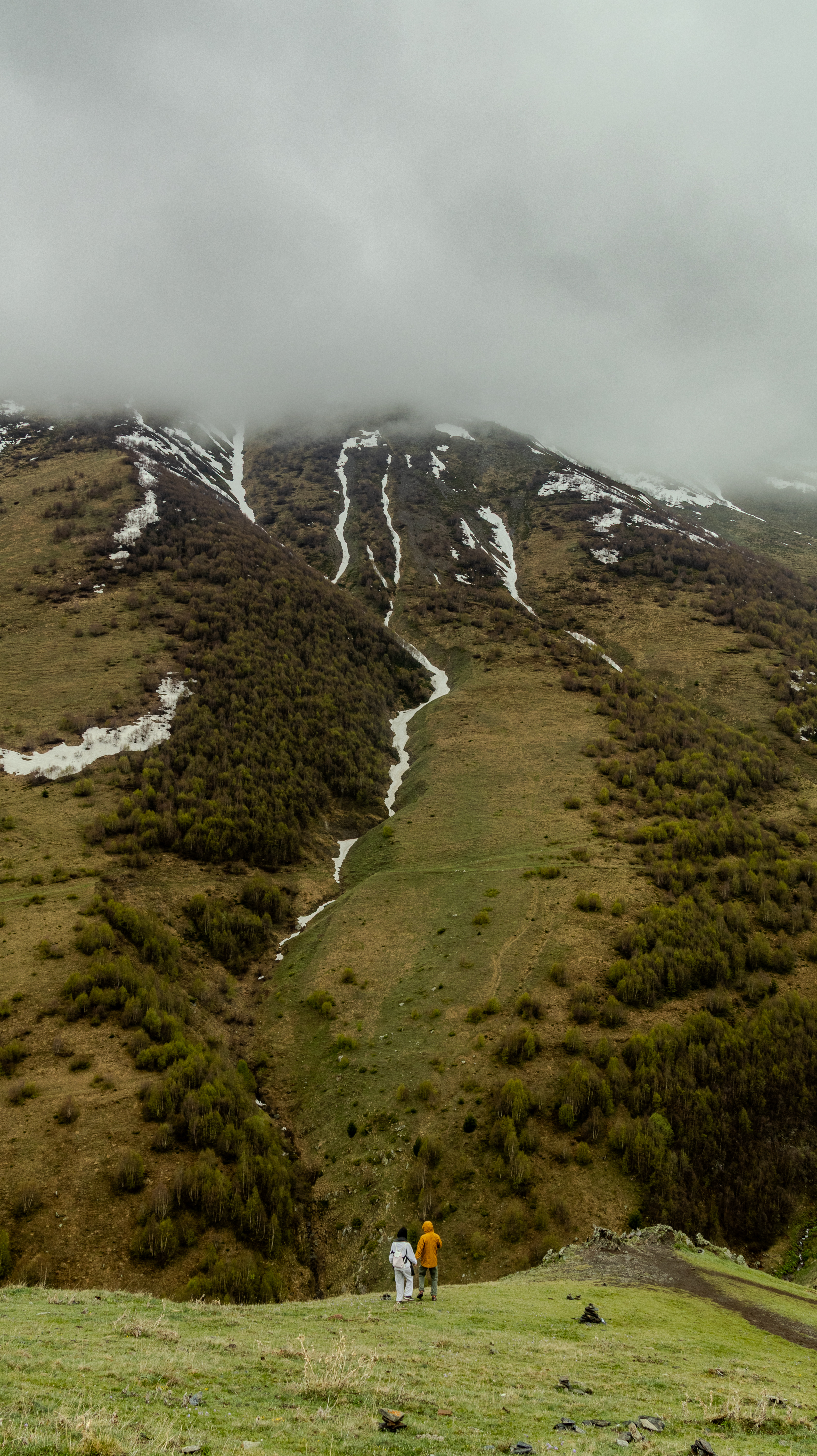 Hikers on a misty snowy mountain, Georgia