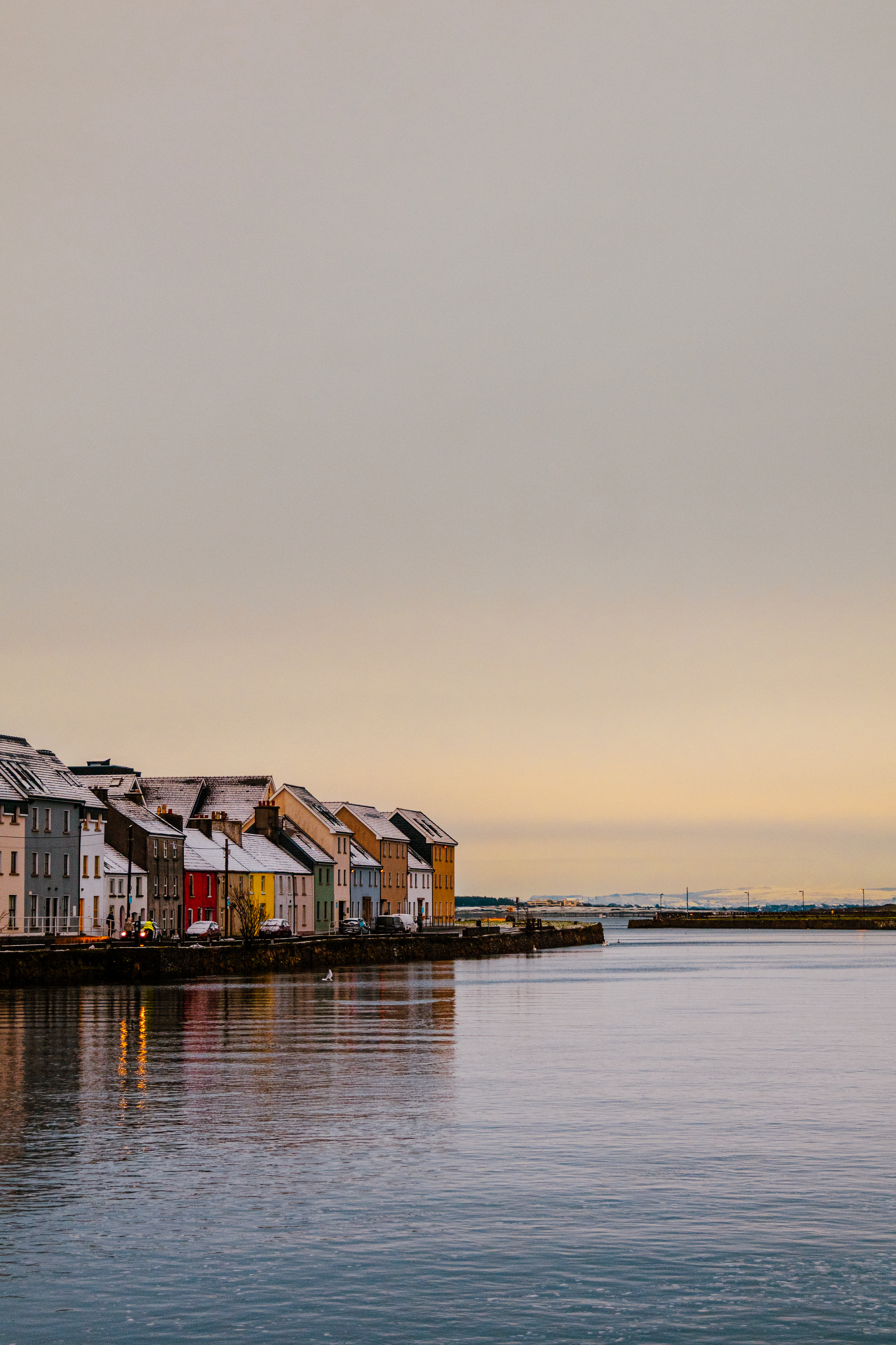 Snow-dusted harbour houses at dusk, Ireland